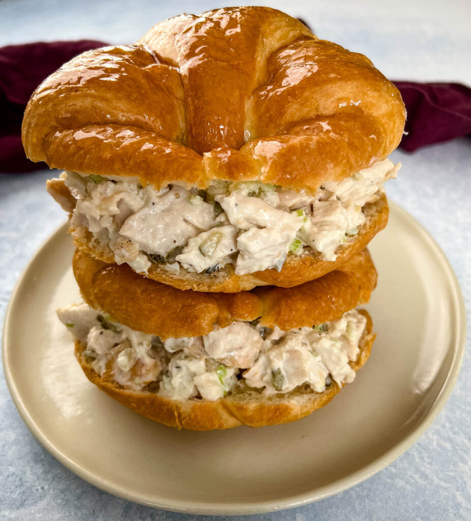 classic chicken salad on a croissant sandwich on a plate