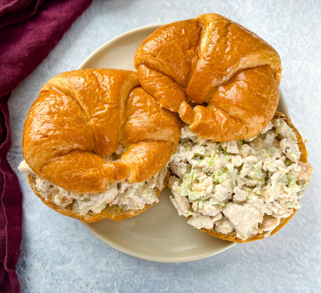 classic chicken salad on a croissant sandwich on a plate