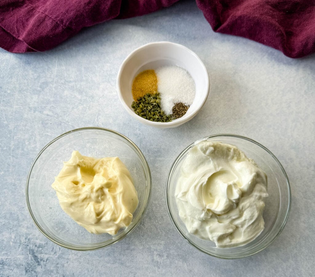spices, mayo, and sour cream in separate glass bowls