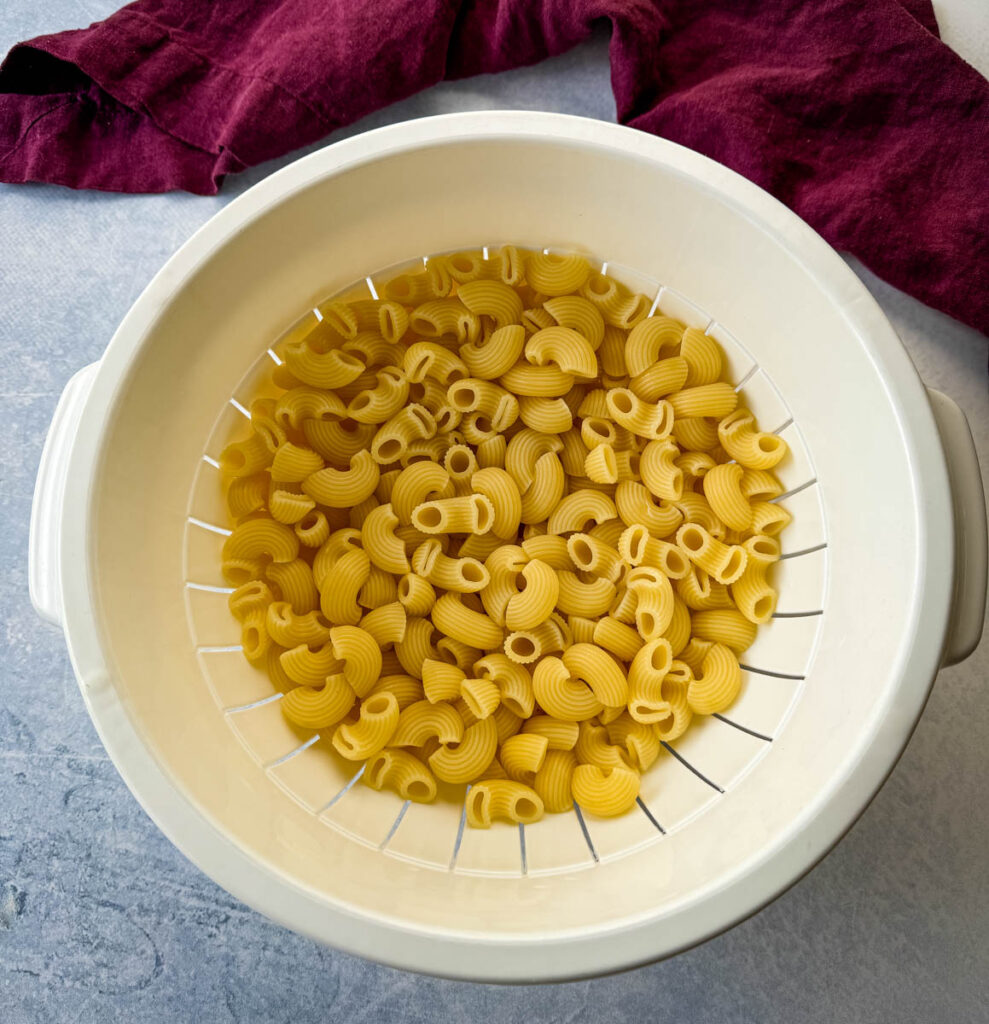 cooked macaroni pasta in a colander