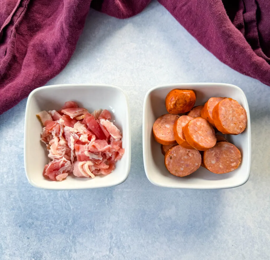uncooked bacon and sausage in white bowls