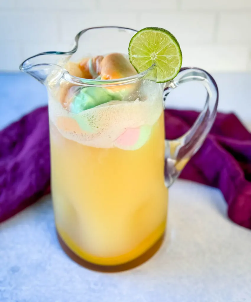 rainbow sherbet punch in a glass pitcher