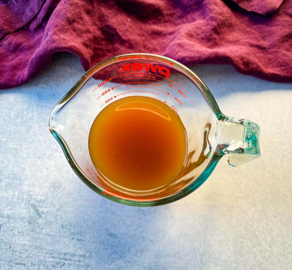 beef stock/ broth in a glass bowl