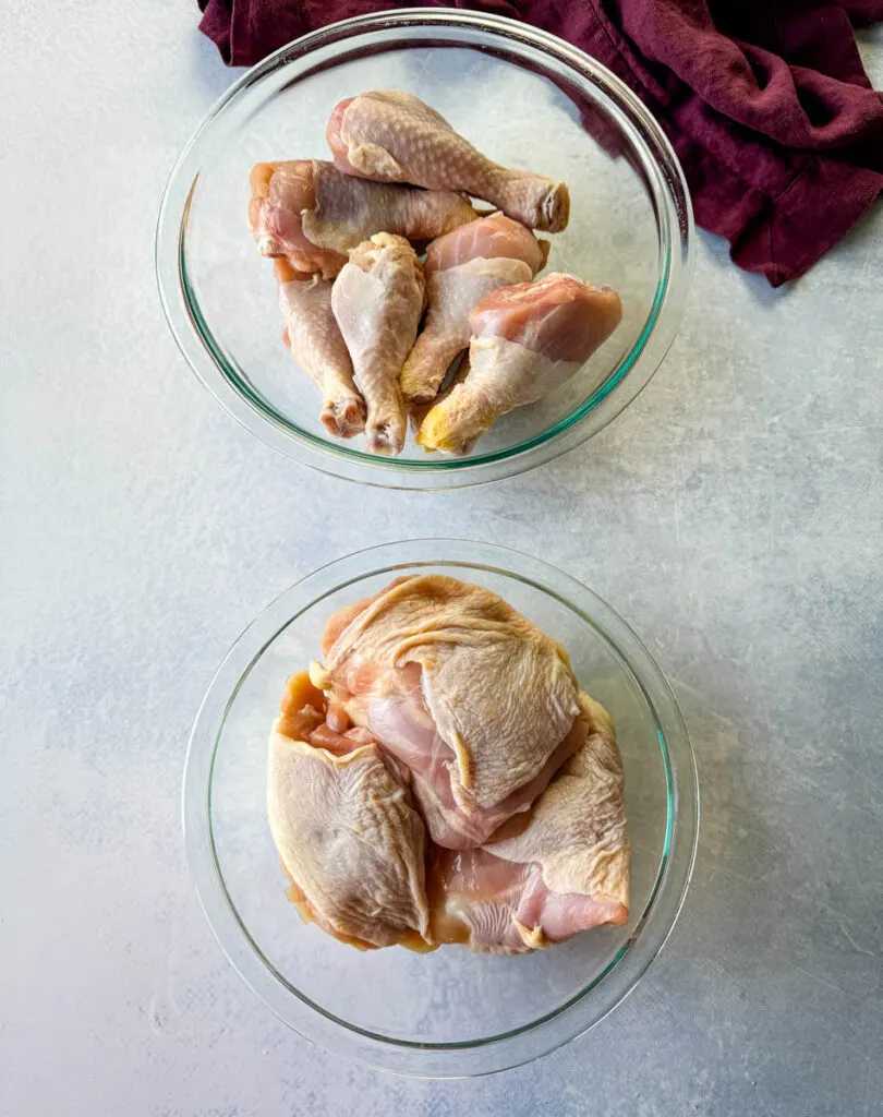 raw chicken thighs and drumsticks in glass bowls