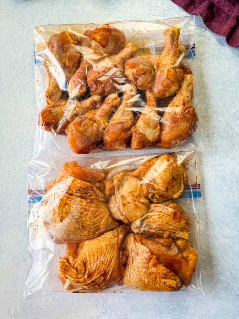 raw, seasoned marinated chicken thighs and drumsticks in a plastic bag