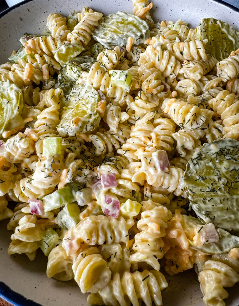 dill pickle pasta salad in a white bowl