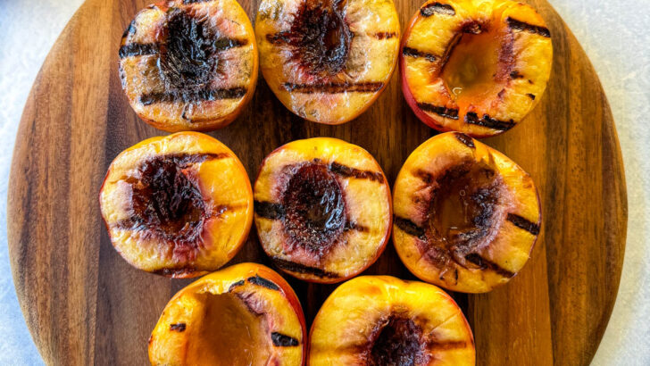 grilled peaches on a flat surface