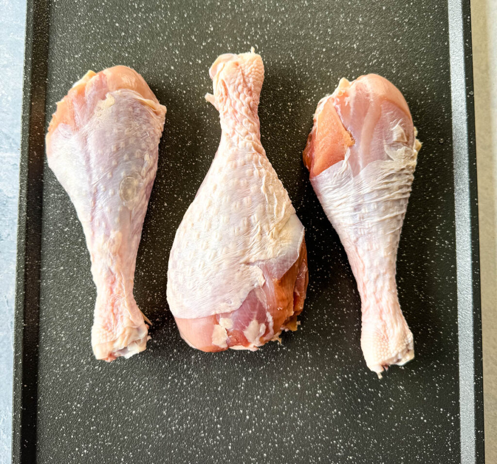 raw turkey legs on a sheet pan