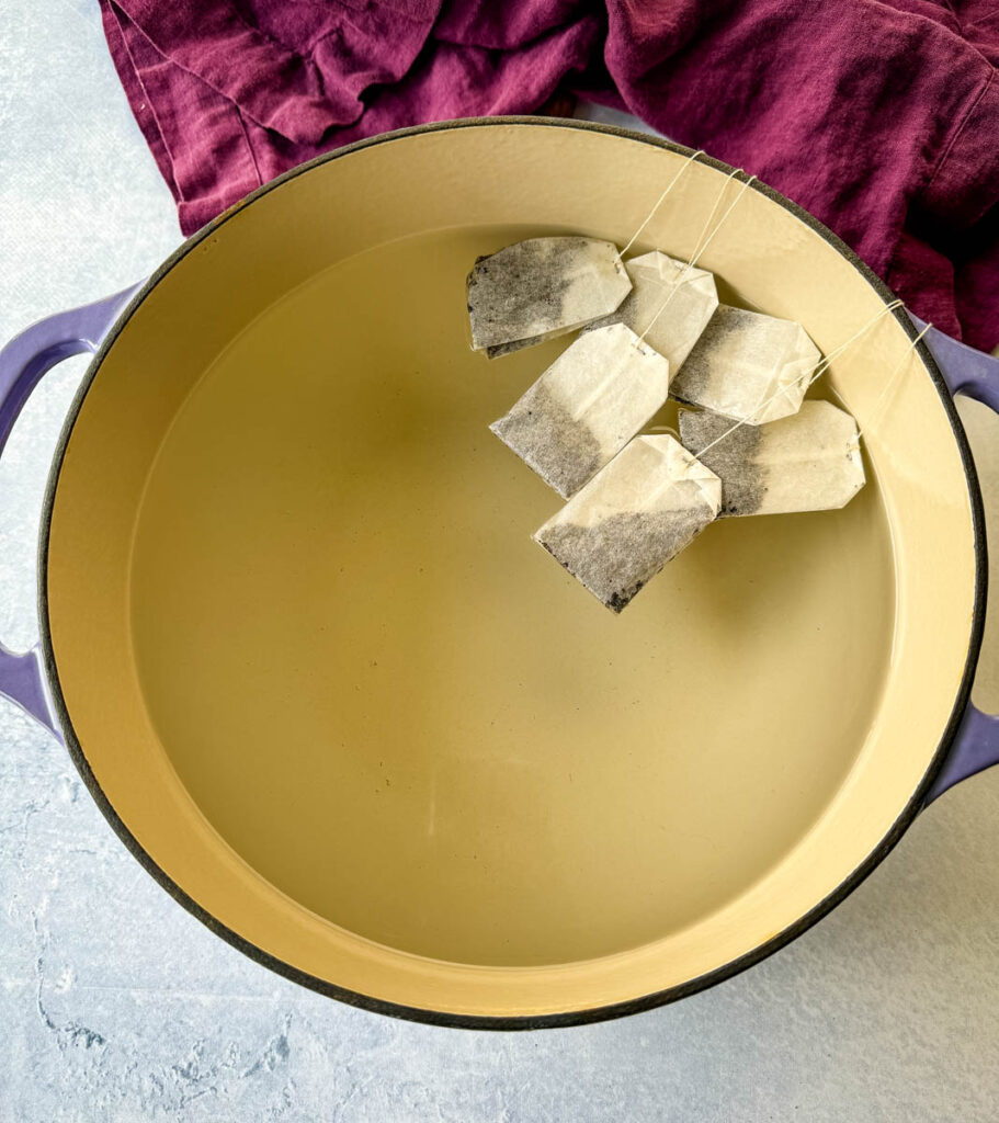 water and teabags in a Dutch oven