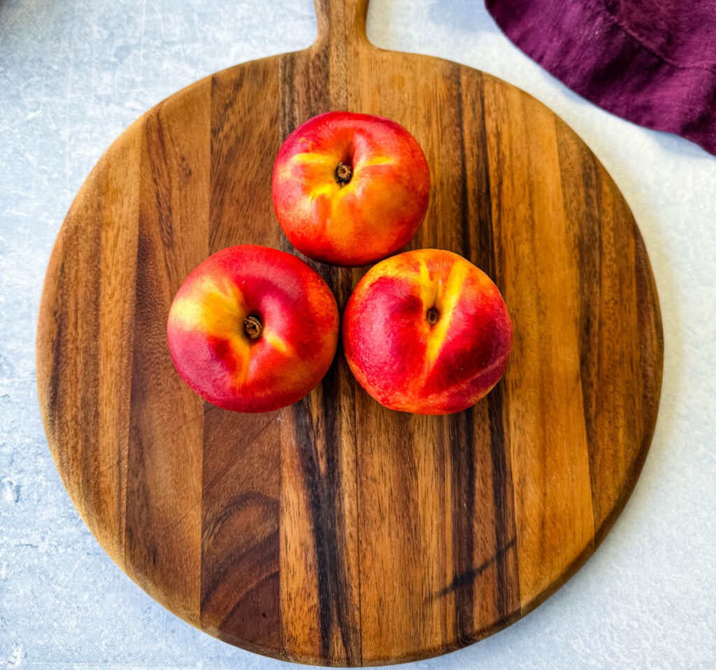 fresh peaches on a flat surface