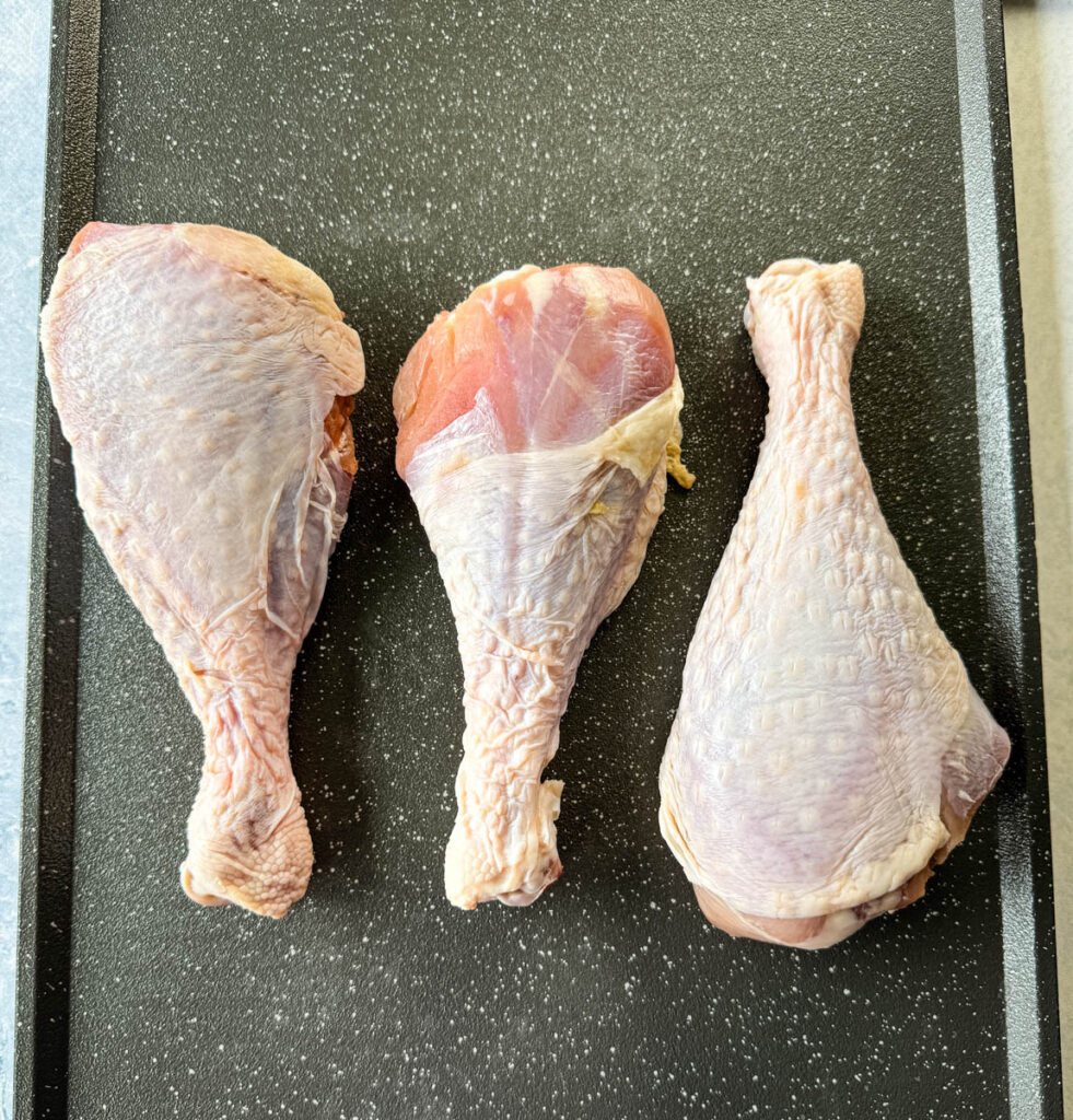 raw turkey legs on a sheet pan