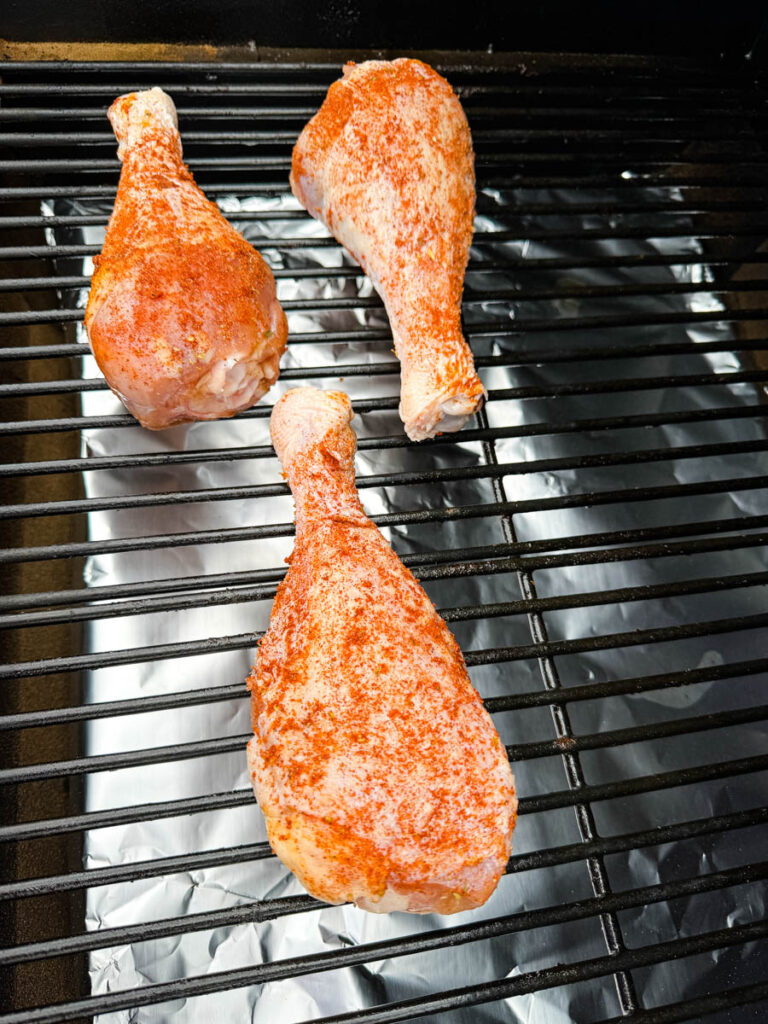 seasoned, raw turkey legs on a Traeger smoker pellet grill