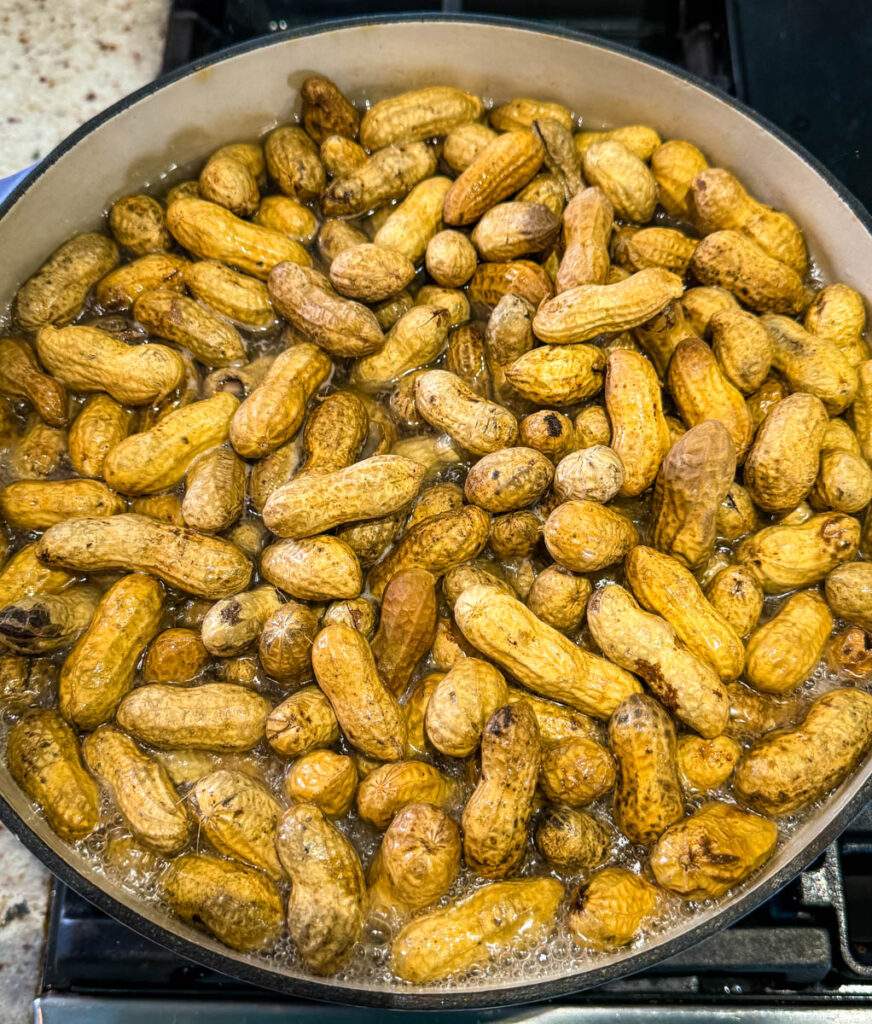 raw peanuts, spices, and water in a Dutch oven