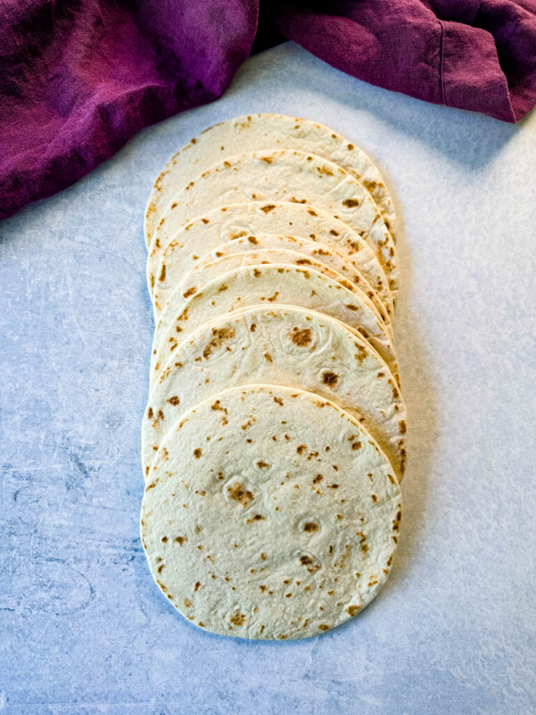8 flour tortillas on a flat surface