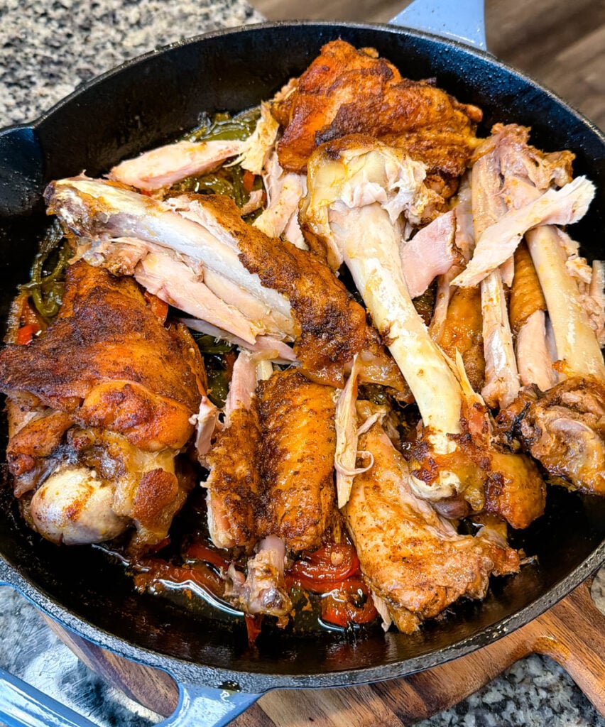 baked turkey wings in a cast iron skillet with chicken broth