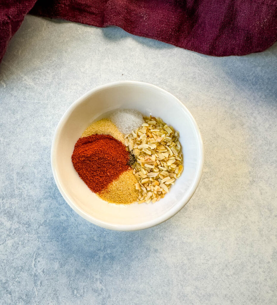 homemade burger rub spices and seasoning in a white bowl