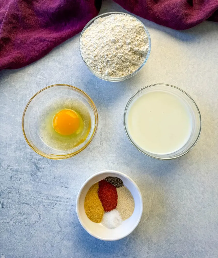 flour, egg, half and half, and spices in separate white bowls
