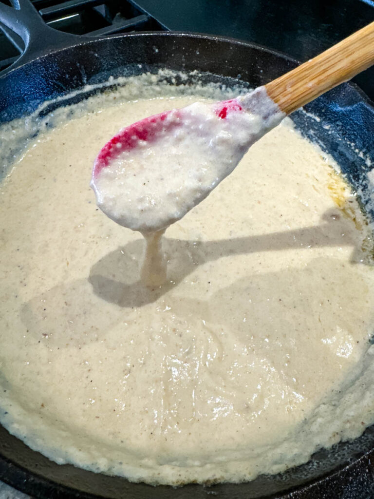 a spoonful of gravy in a cast iron skillet