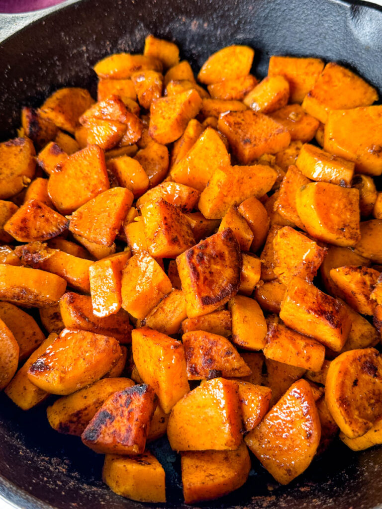 fried sweet potatoes in a cast iron skillet