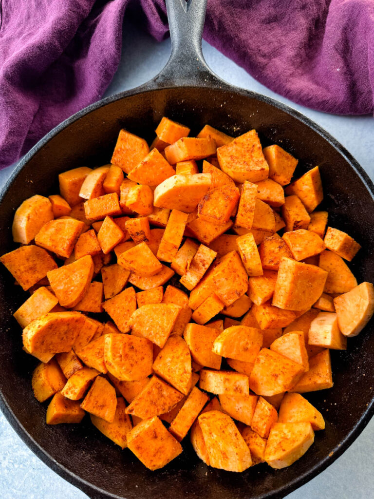 uncooked sweet potatoes in a cast iron skillet