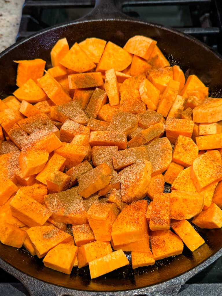 uncooked sweet potatoes in a cast iron skillet