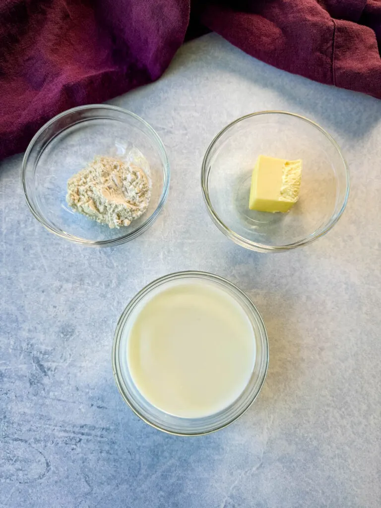 flour, butter, and milk in separate glass bowls