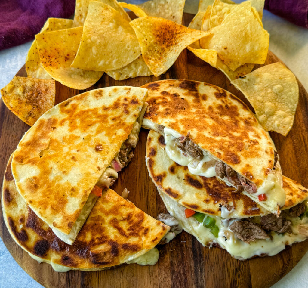 Philly cheesesteak quesadillas on a plate with chips