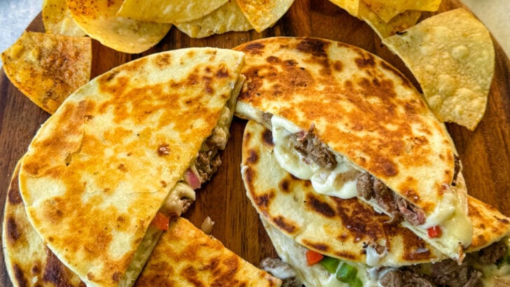 Philly cheesesteak quesadillas on a plate with chips