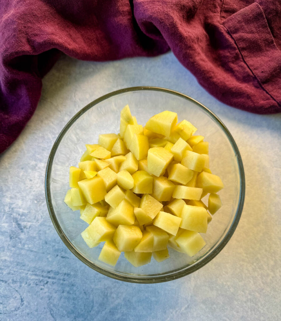 raw, diced potatoes in a glass bowl