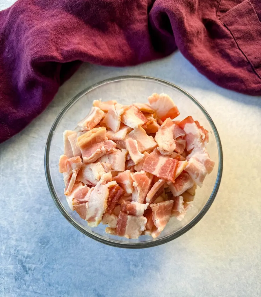 diced pieces of raw bacon in a glass bowl