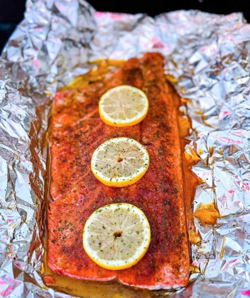 grilled salmon in foil with fresh lemons
