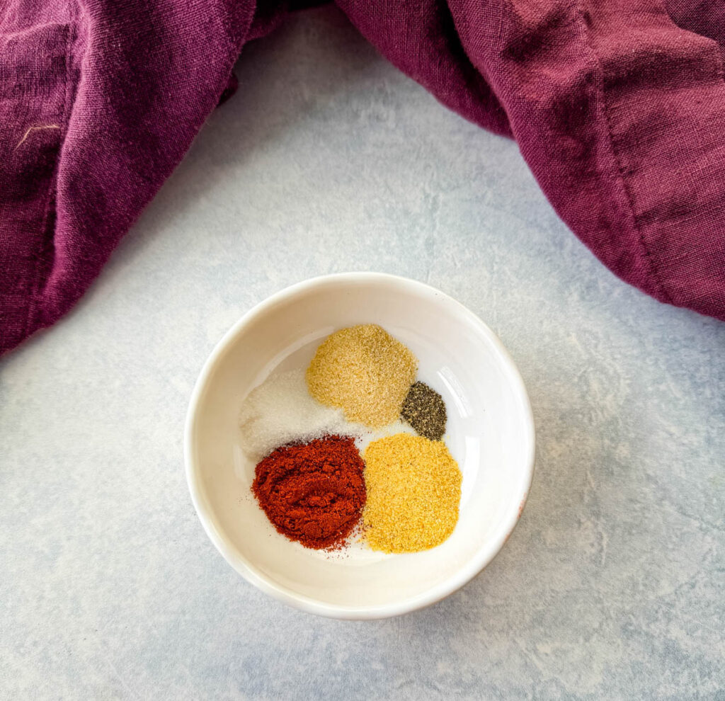 paprika, garlic powder, onion powder, salt, and pepper in a white bowl