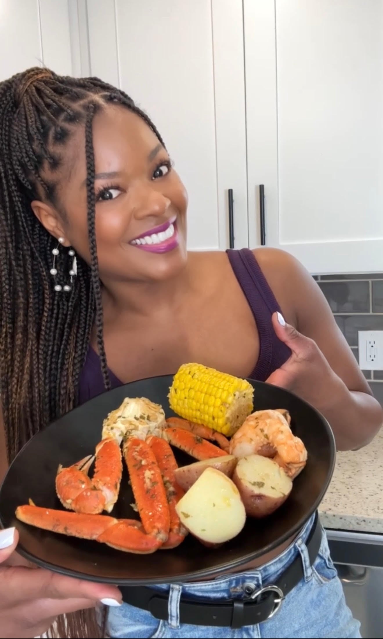 person holding a seafood boil on a plate