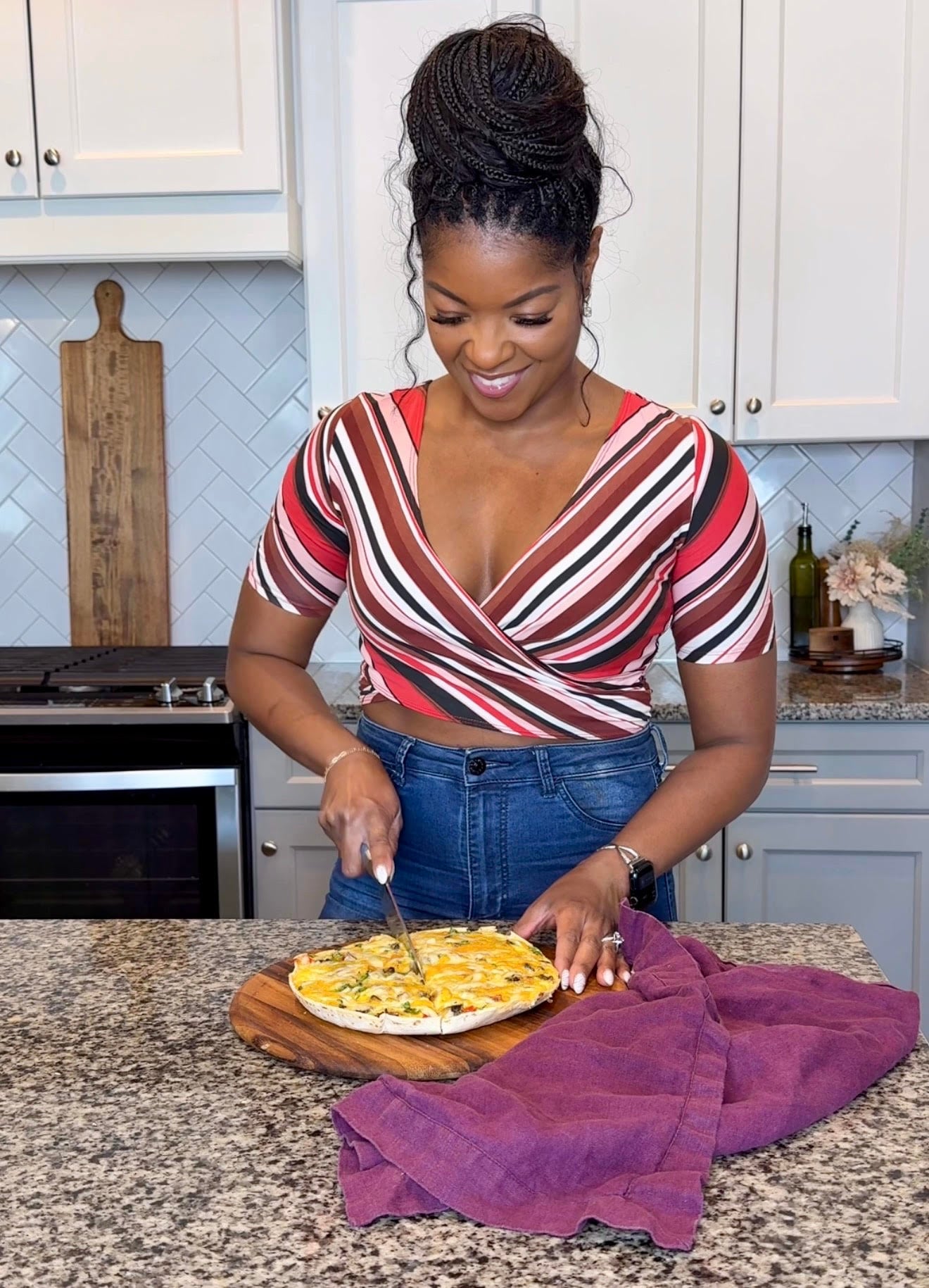 person slicing breakfast pizza