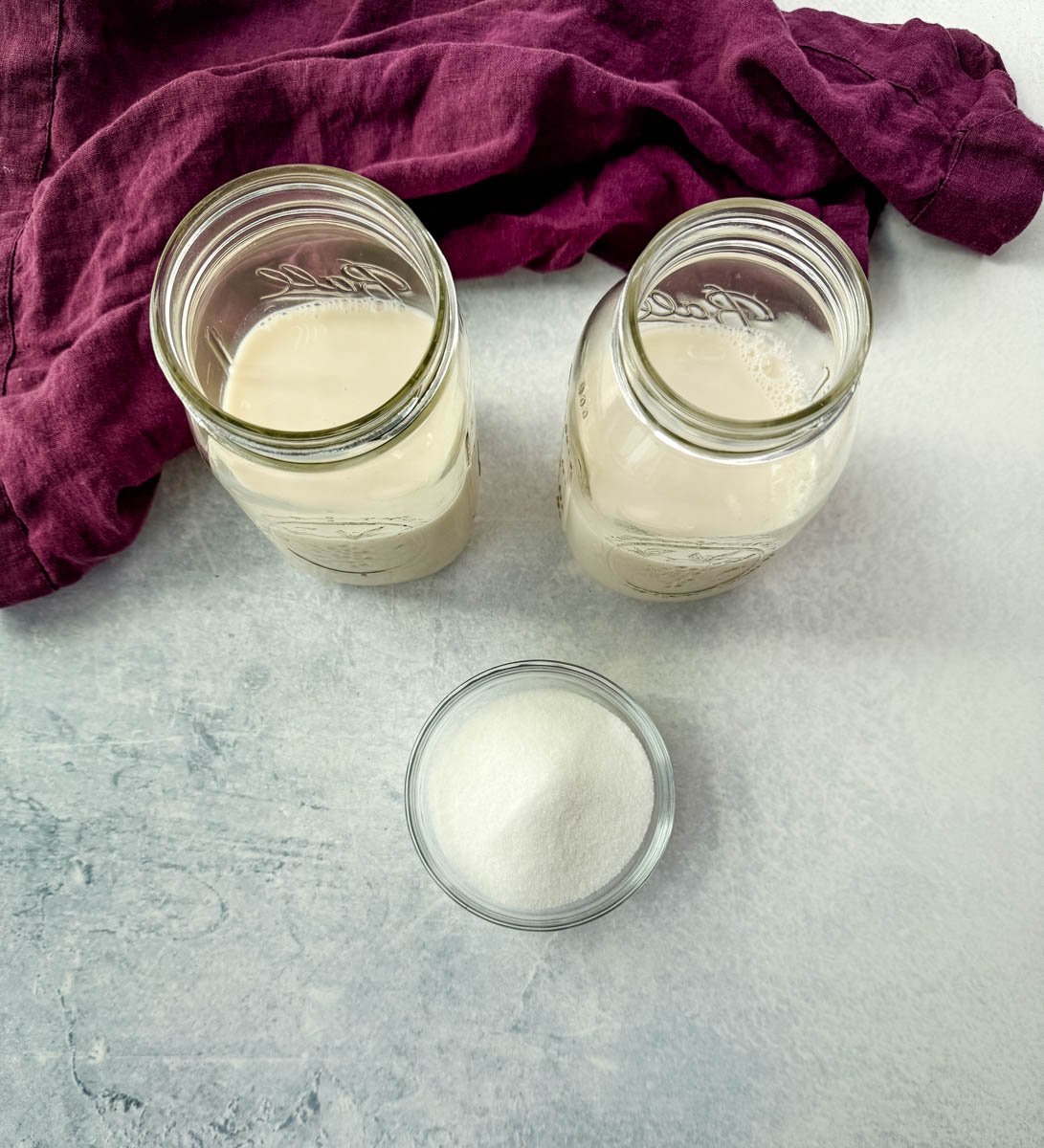 milk and sugar in separate glass bowls and cups