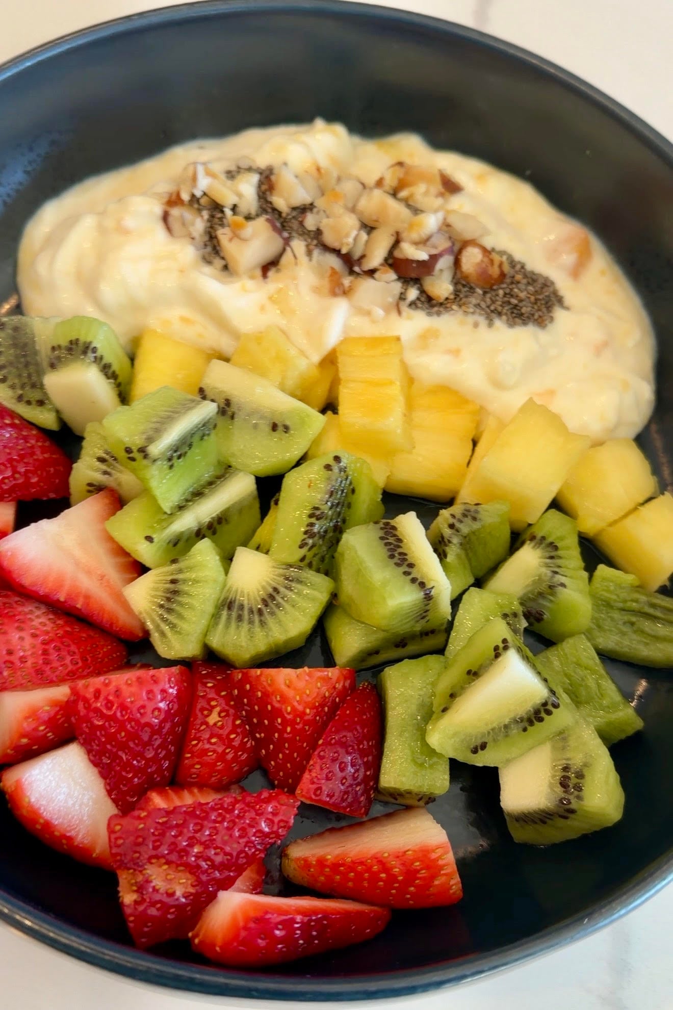 Greek yogurt, nuts, kiwi, pineapple, and fresh strawberries