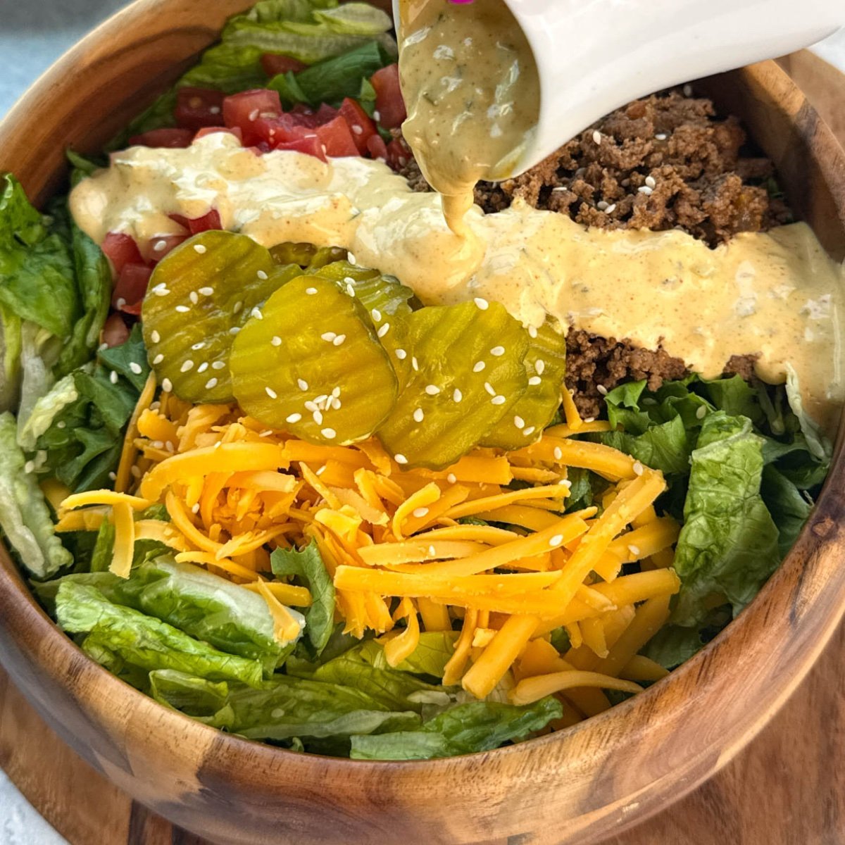 homemade big mac sauce drizzled over a burger salad bowl