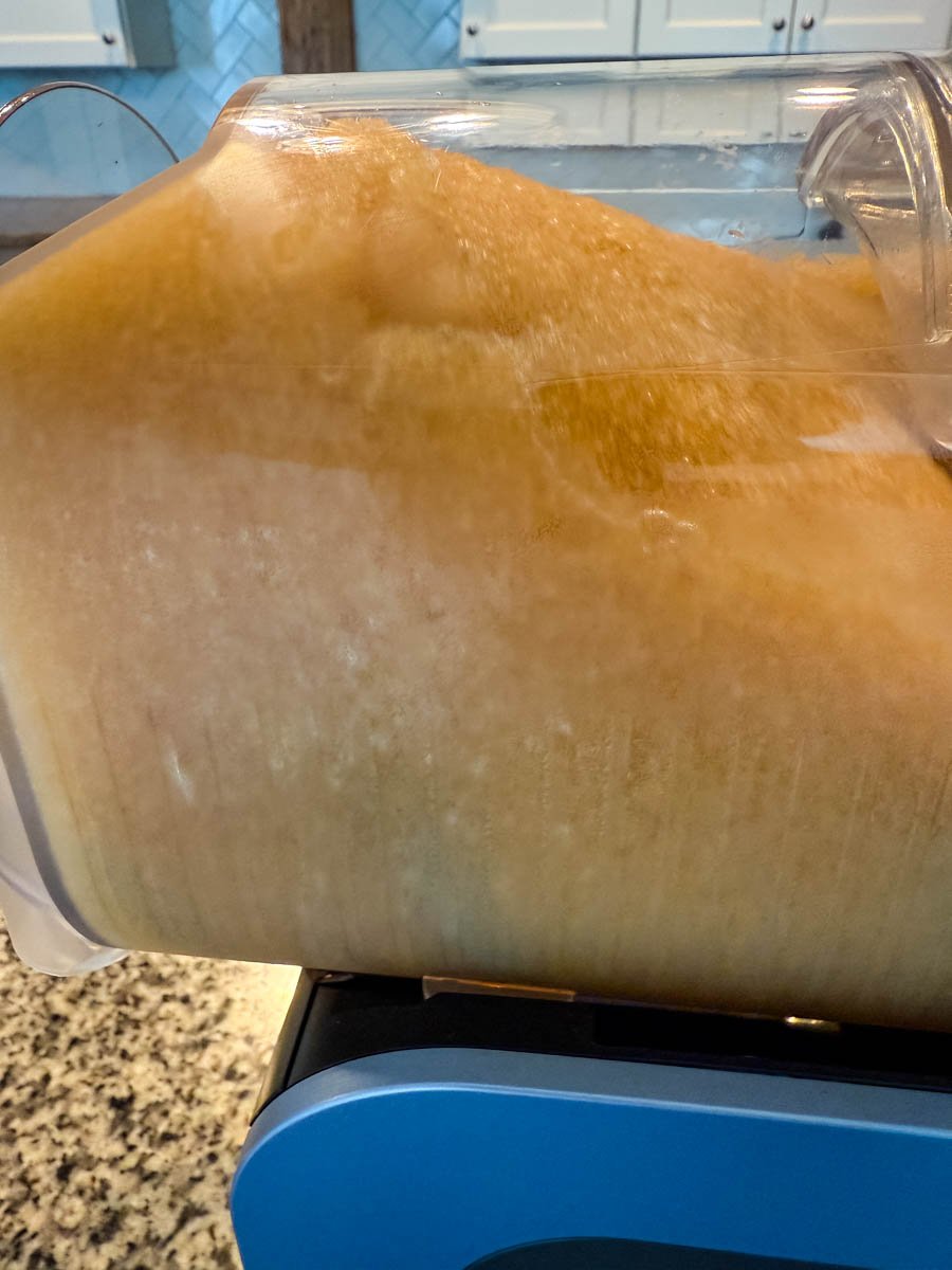 A close-up side view of the slushed iced tea fully formed inside the Ninja Slushi machine.