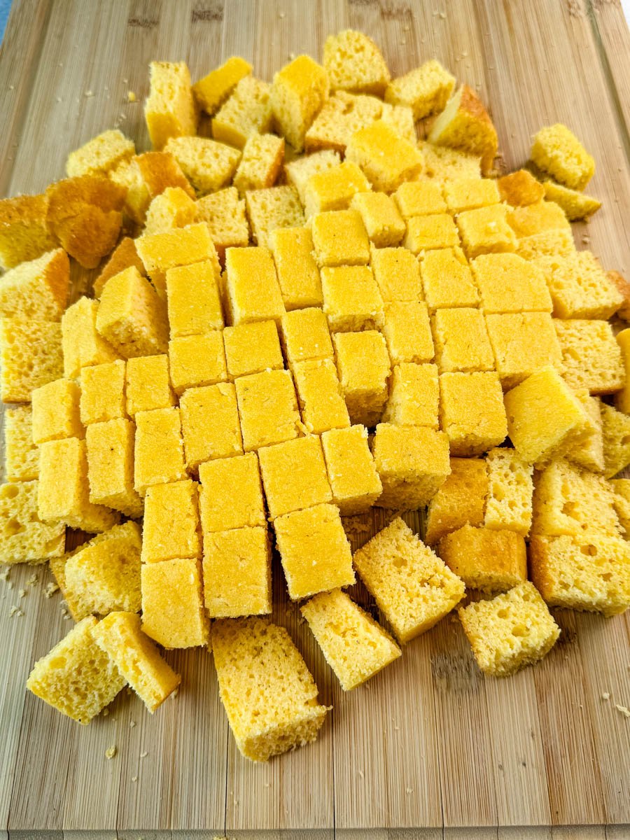Cubes of golden Southern cornbread freshly cut and ready to be layered for the salad.