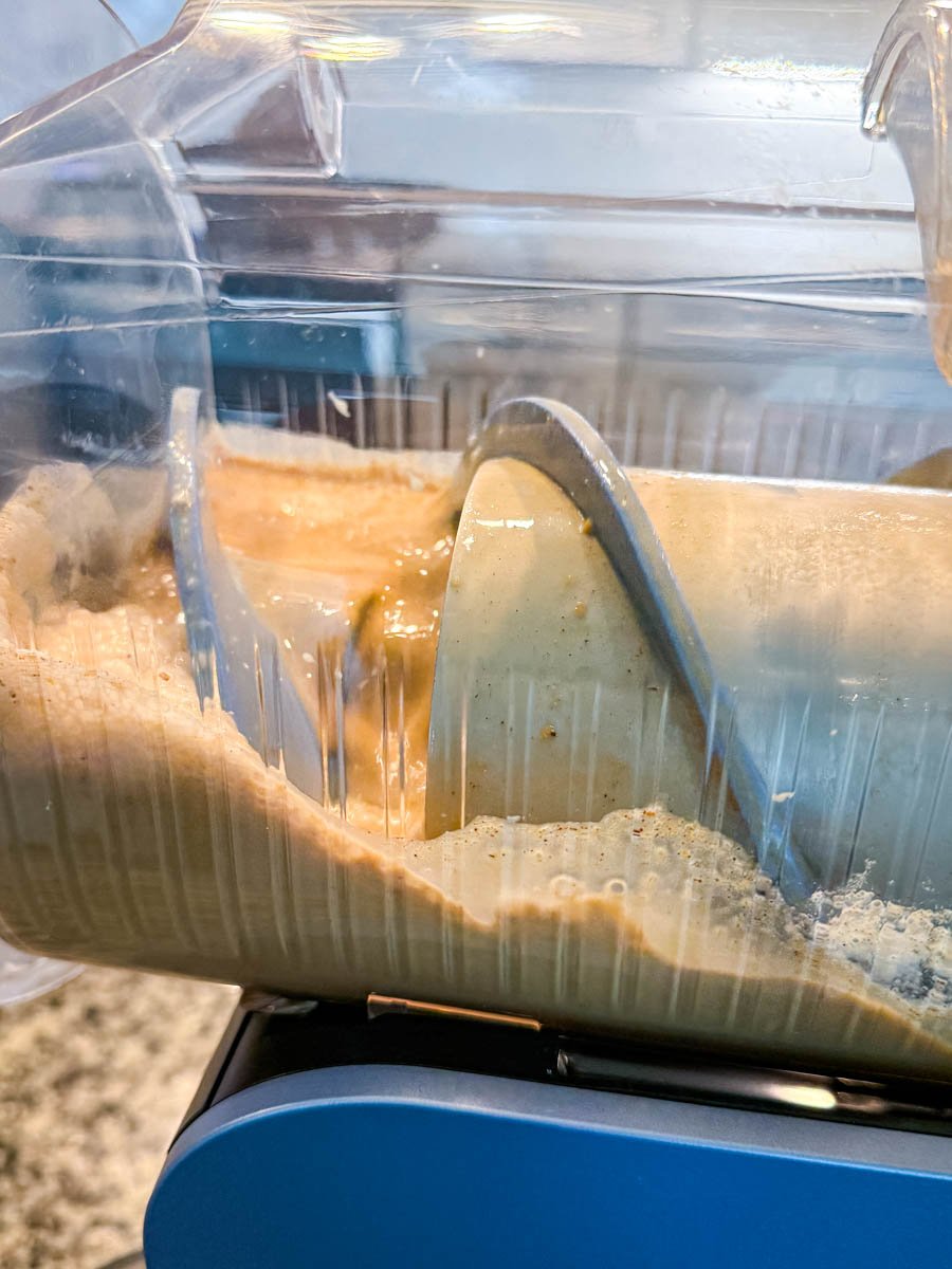 Pumpkin spice coffee frappe swirling inside the Ninja Slushi machine as it mixes.