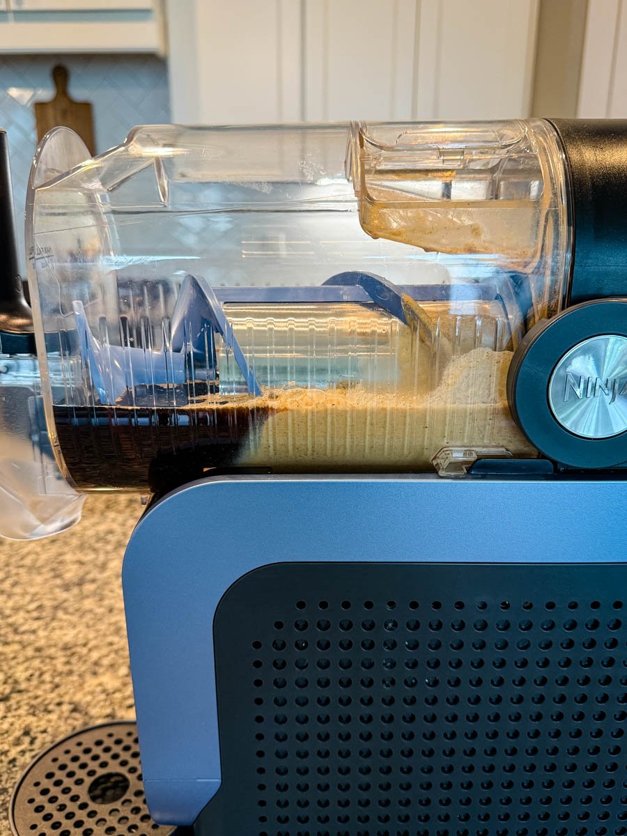 Coffee and pumpkin spice mixture being processed inside a Ninja Slushi machine.
