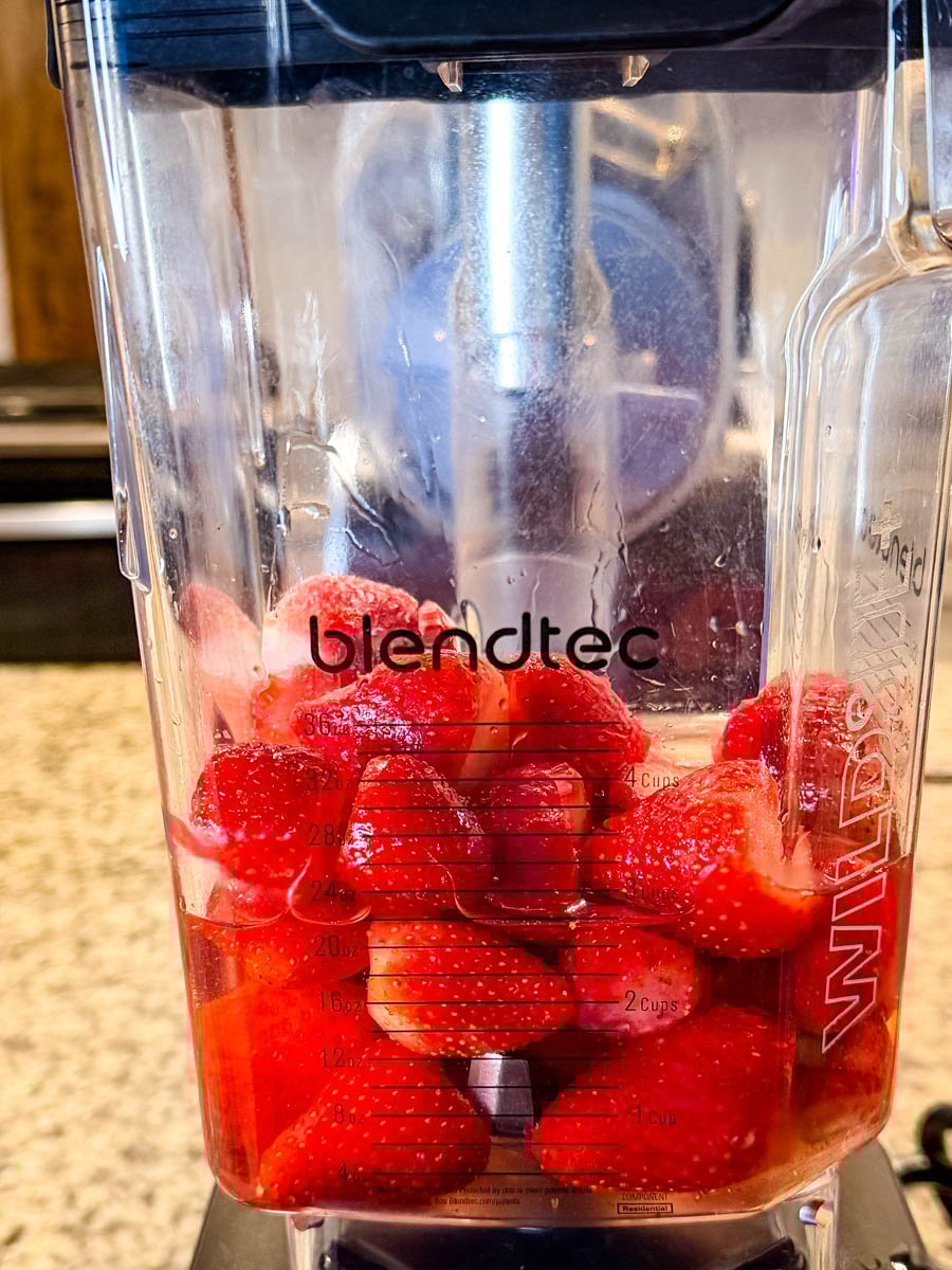 frozen strawberries in a blender
