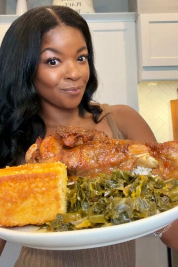 person holding a plate of baked turkey wings