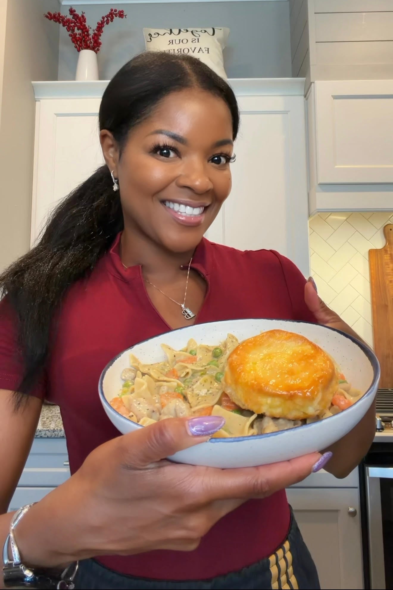 Brandi Crawford holding bowl of chicken pot pie casserole