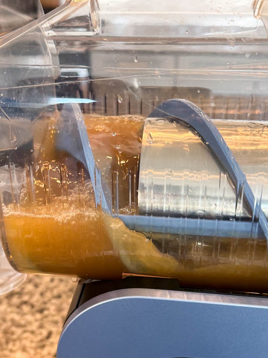 A partially frozen Butter Beer mixture inside the slushie chamber, with visible icy ridges forming as the machine churns.