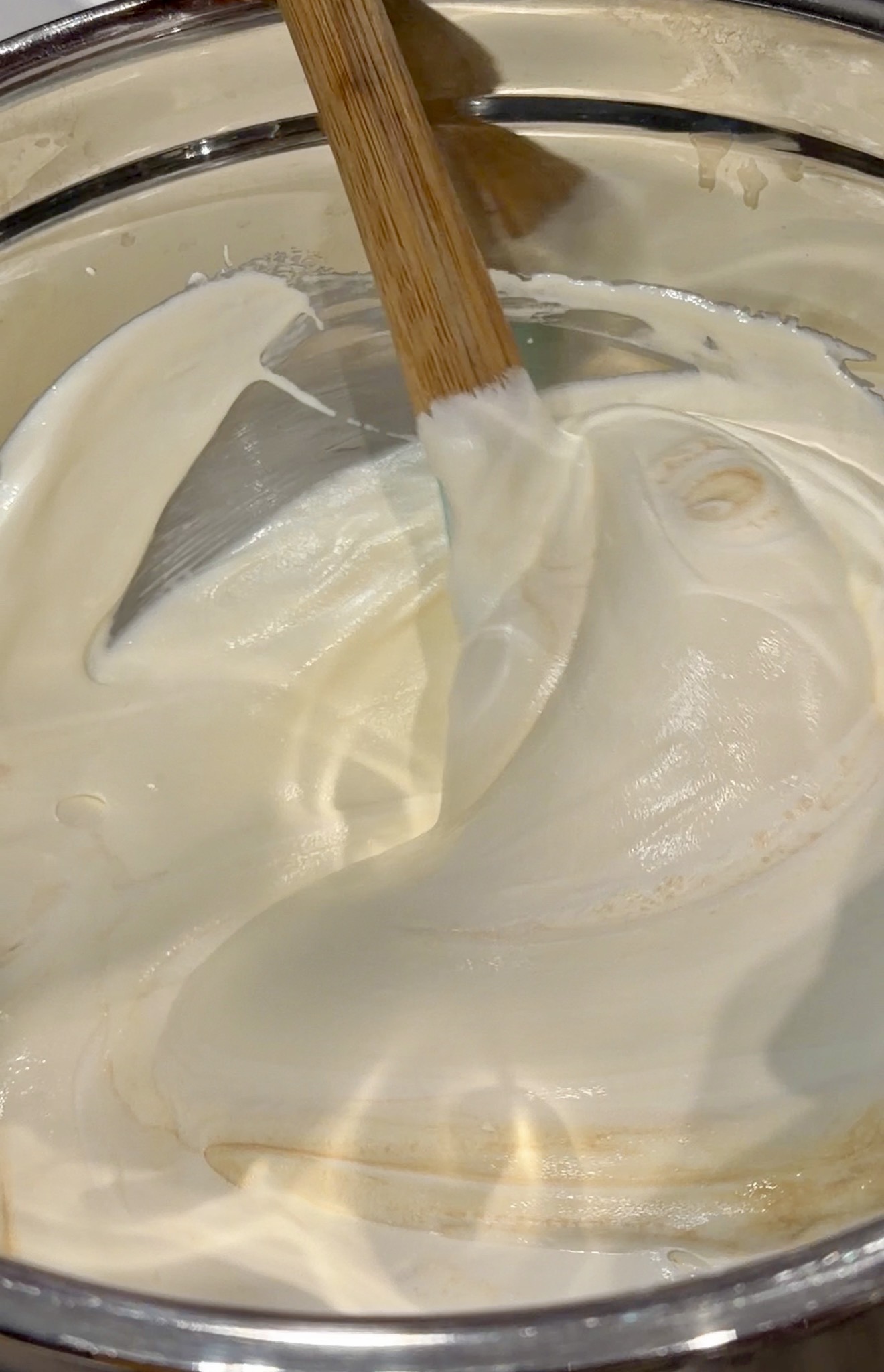 Close-up of folded banana pudding mixture showing a light, creamy, and smooth consistency.