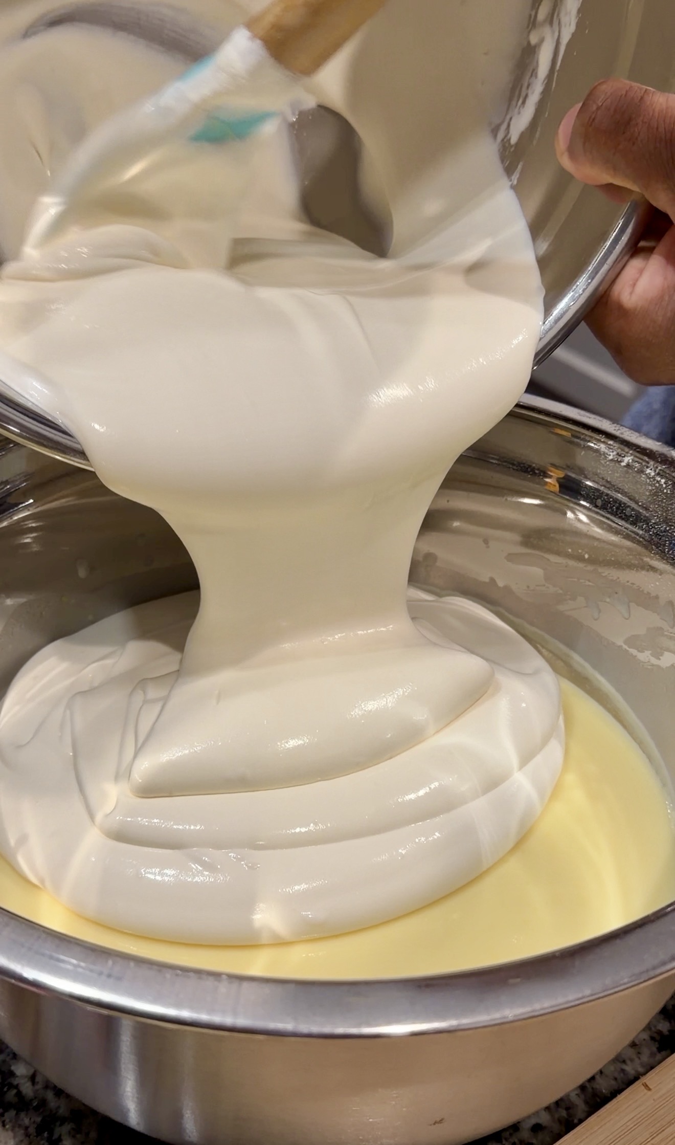 Thick, smooth banana pudding mixture poured into an empty baking dish, showing a creamy, glossy texture.