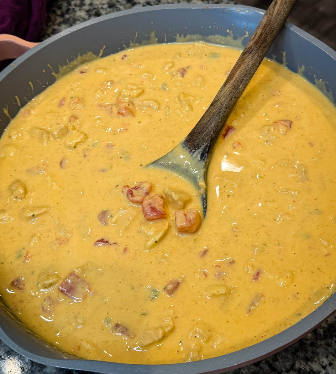 Large skillet filled with creamy Chicken Rotel dip without Velveeta, showing the cheese sauce and chunks of chicken, tomatoes, and green chiles.