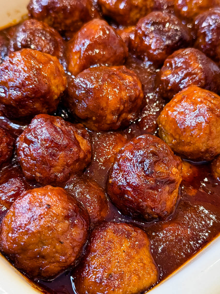 Close-up of BBQ meatballs showing sticky sweet sauce and tender texture