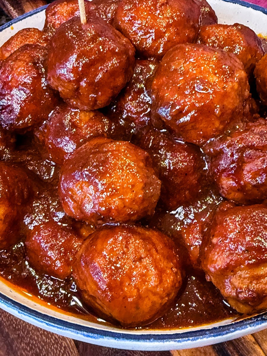 Baked BBQ meatballs coated in thick caramelized sauce in a casserole dish